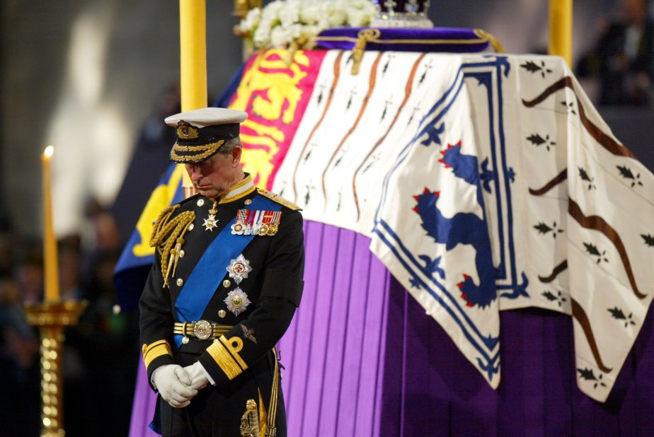 Charles stands beside his grandmother's coffin while it lies in state at Westminster Hall in London in April 2002.