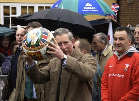 Prince Charles carries a specially painted football through the streets of Ashbourne, England, in March 2003.