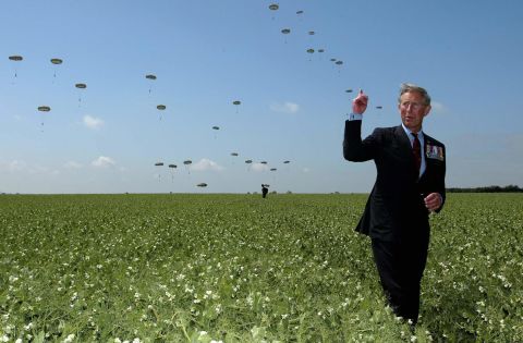 Prince Charles watches a parachute regiment during a D-Day re-enactment in Ranville, France, in June 2004.