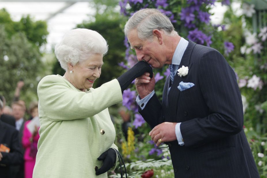 Queen Elizabeth II presents Charles with the Royal Horticultural Society's Victoria Medal of Honor during a visit to the Chelsea Flower Show in London in May 2009.
