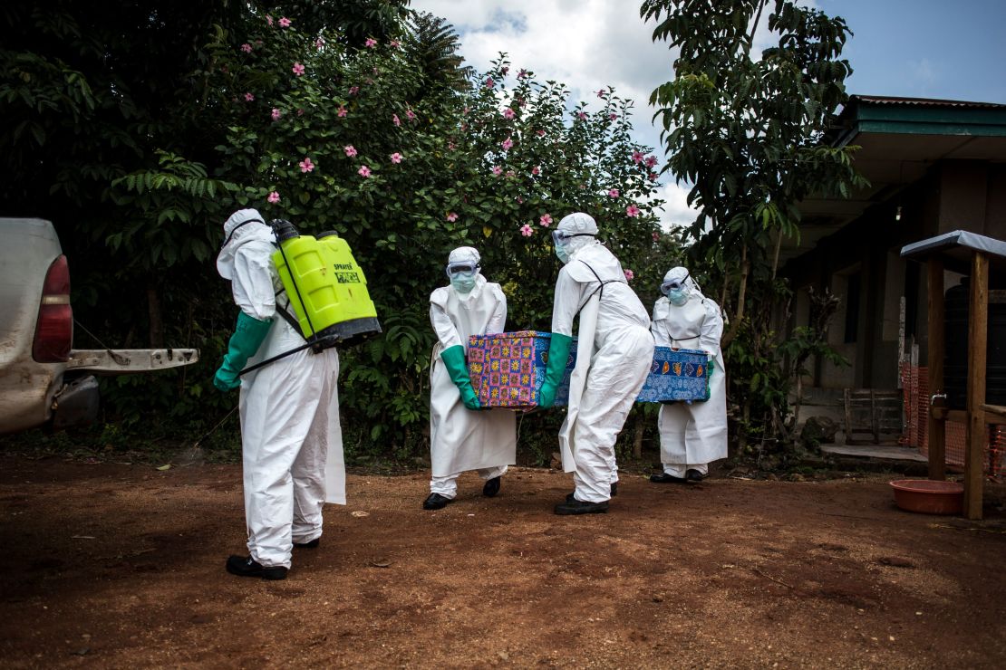 Health workers carry the body of a patient with unconfirmed Ebola virus on August 22, 2018, in the Democratic Republic of Congo.