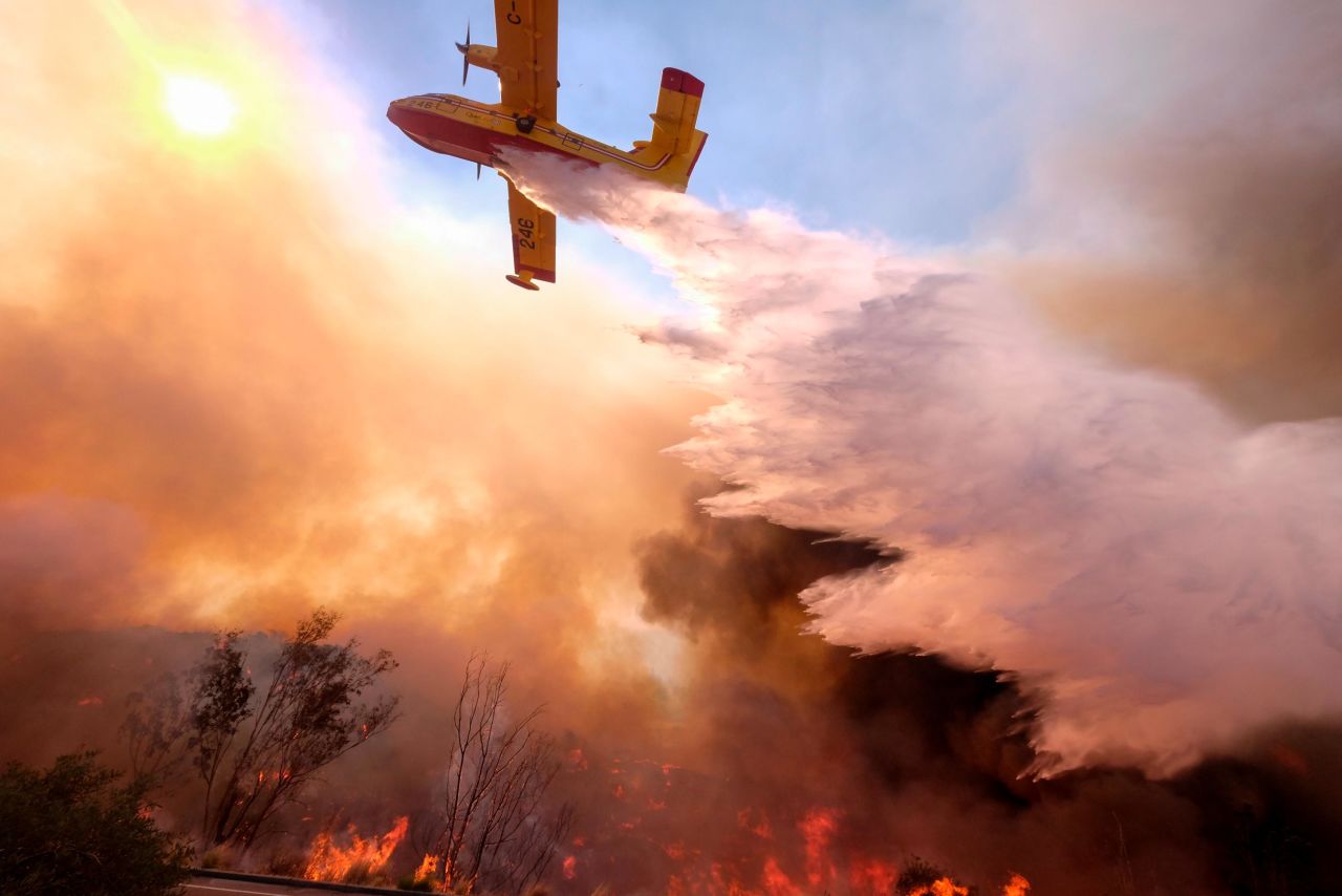 An air tanker drops water on a fire along the Ronald Reagan Freeway in Simi Valley on Monday, November 12.