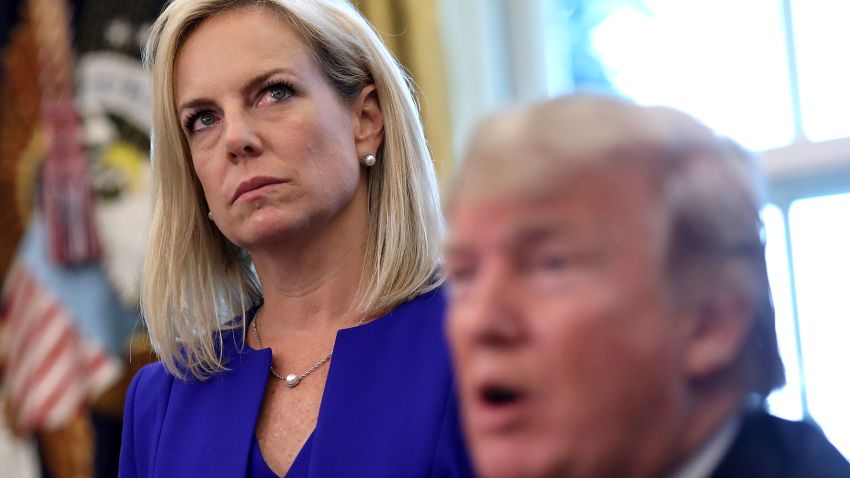 WASHINGTON, DC - JUNE 20:  Department of Homeland Security Secretary Kirstjen Nielsen (L) listens as U.S. President Donald Trump answers questions after signing an executive order that will end the practice of separating family members who are apprehended while illegally entering the United States on June 20, 2018 in Washington, DC. The order would detain parents and children together. (Photo by Win McNamee/Getty Images)