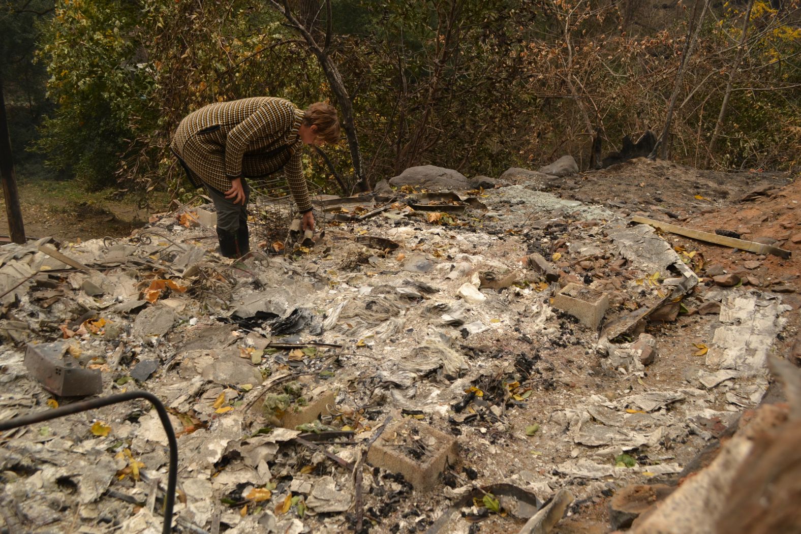 Betsy Ann Cowley walks through Pulga, near where investigators were trying to determine the cause of the Camp Fire.