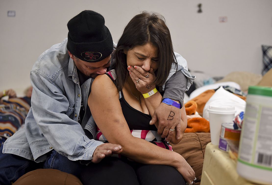 Joseph Grado embraces his wife, Susan, at a shelter this week in Chico after losing their home to fire.