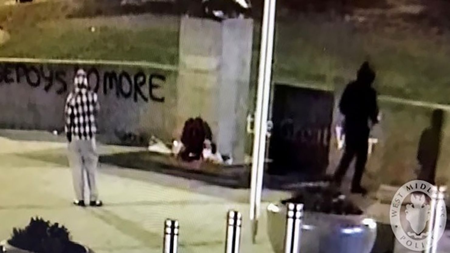 The security camera image released by police shows two alleged vandals by the statue on Friday morning.