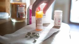 Kristen Kilmer spreads out her daily medications, including Lynparza (center), which costs nearly $17,000 per month. (Kristina Barker for KHN)