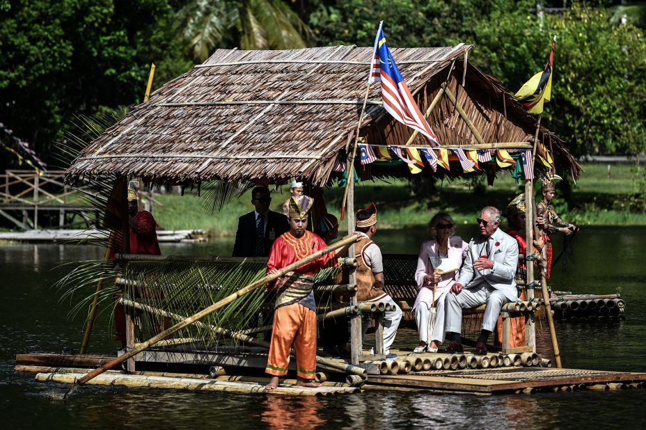 Charles and Camilla ride on a raft while visiting the island of Borneo in November 2017.