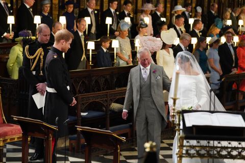 Prince Charles accompanies his future daughter-in-law, Meghan Markle, as she is married to Prince Harry in May 2018.