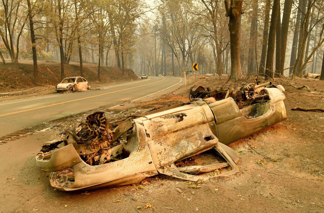 Burnt cars litter the sides of a road in Paradise, California. 