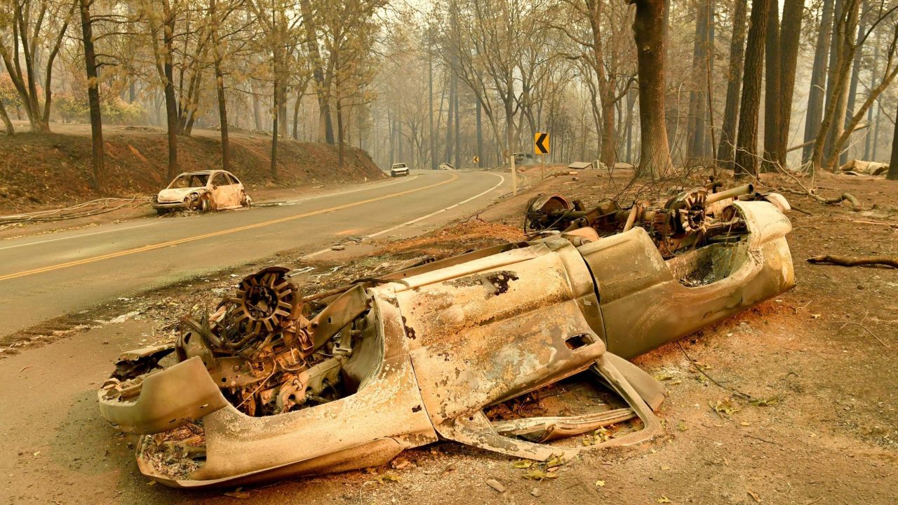 Burnt cars litter the sides of a road in Paradise, California.
