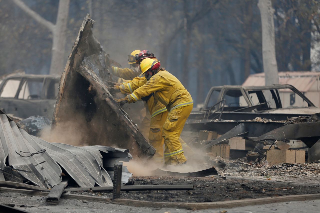 Firefighters search through the remains of a Paradise house on November 13.