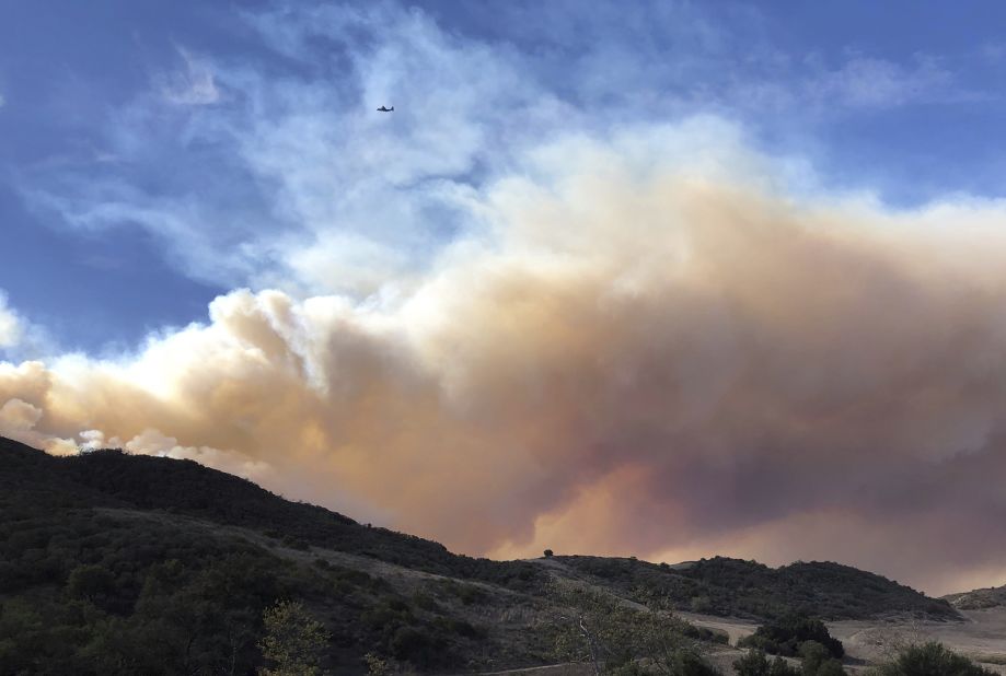 Smoke fills the horizon on November 13 as an airplane flies near a flare-up of the Woolsey Fire near Lake Sherwood.