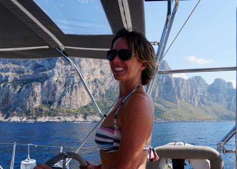 Kellie at the helm of Boomerang, sailing along the north coast of Sicily. We were motor-sailing which means one sail was being augmented by the engine to keep a constant speed of sknots.
