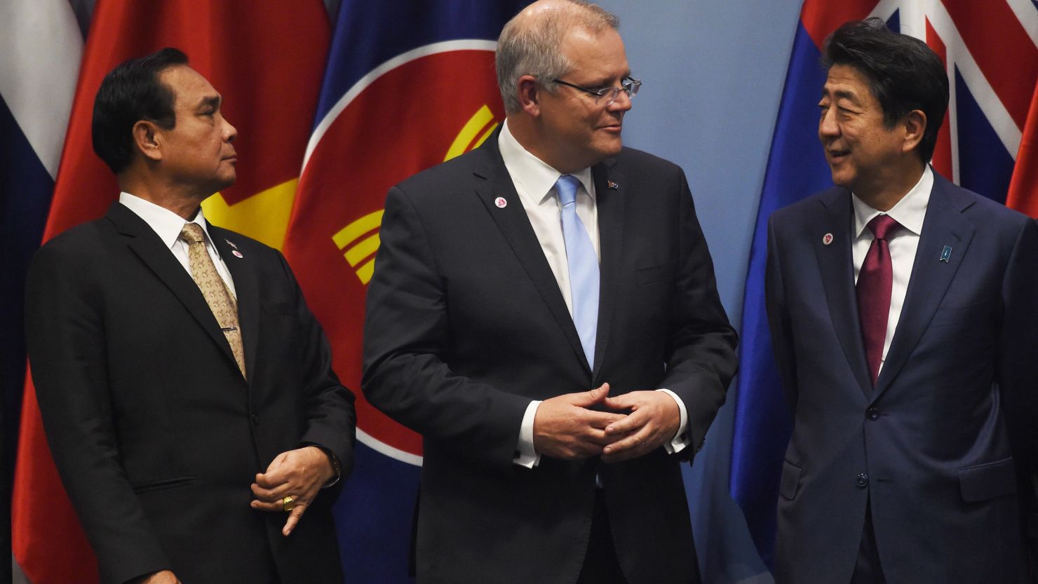 Thai Prime Minister Prayut Chan-O-Cha (left) looks on as Australia's Prime Minister Scott Morrison (center) talks with Japan's Prime Minister Shinzo Abe as they arrive to pose for a group photo in Singapore on November 14.