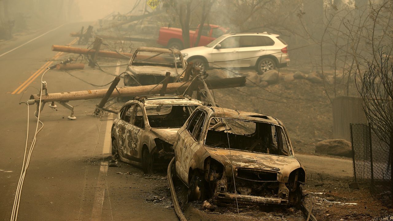Power lines rest on cars that were burned by the Camp Fire on November 10, 2018 in Paradise, California.