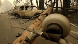 PARADISE, CA - NOVEMBER 10:  Power lines rest on cars that were burned by the Camp Fire on November 10, 2018 in Paradise, California. Fueled by high winds and low humidity, the rapidly spreading Camp Fire ripped through the town of Paradise and has quickly charred 100,000 acres and has destroyed over 6,700 homes and businesses in a matter of hours. The fire is currently at 20 percent containment.  (Photo by Justin Sullivan/Getty Images)