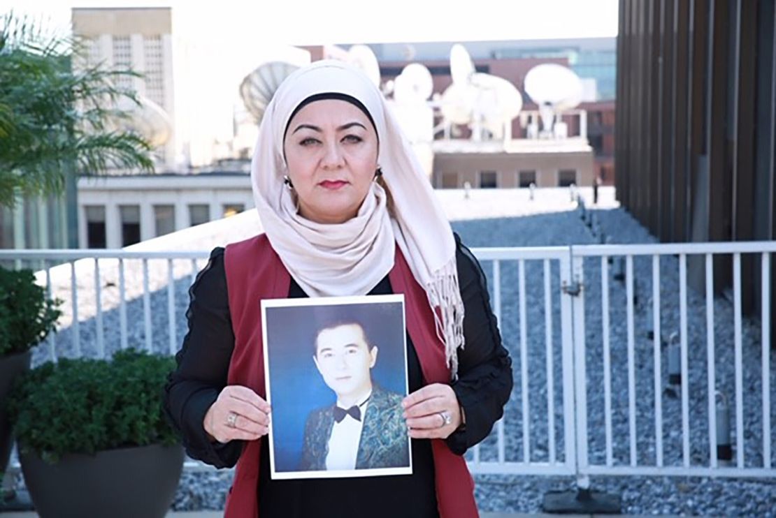 Uyghur journalist Gulchehra Hoja holds a pictures of her brother who has been missing in Xinjiang for more than a year