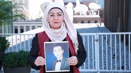 Uyghur journalist Gulchehra Hoja holds a pictures of her brother who has been missing in Xinjiang for more than a year