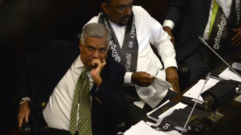 Sri Lanka's ousted prime minister Ranil Wickremesinghe (L) looks on during Wednesday's  parliamentary session, November 14, 2018. 