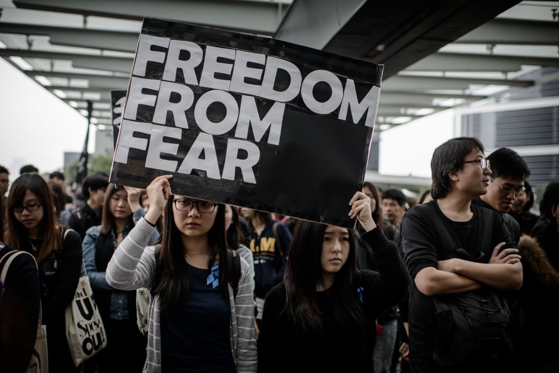Protesters display placards during a rally  to support press freedom in Hong Kong on March 2, 2014.