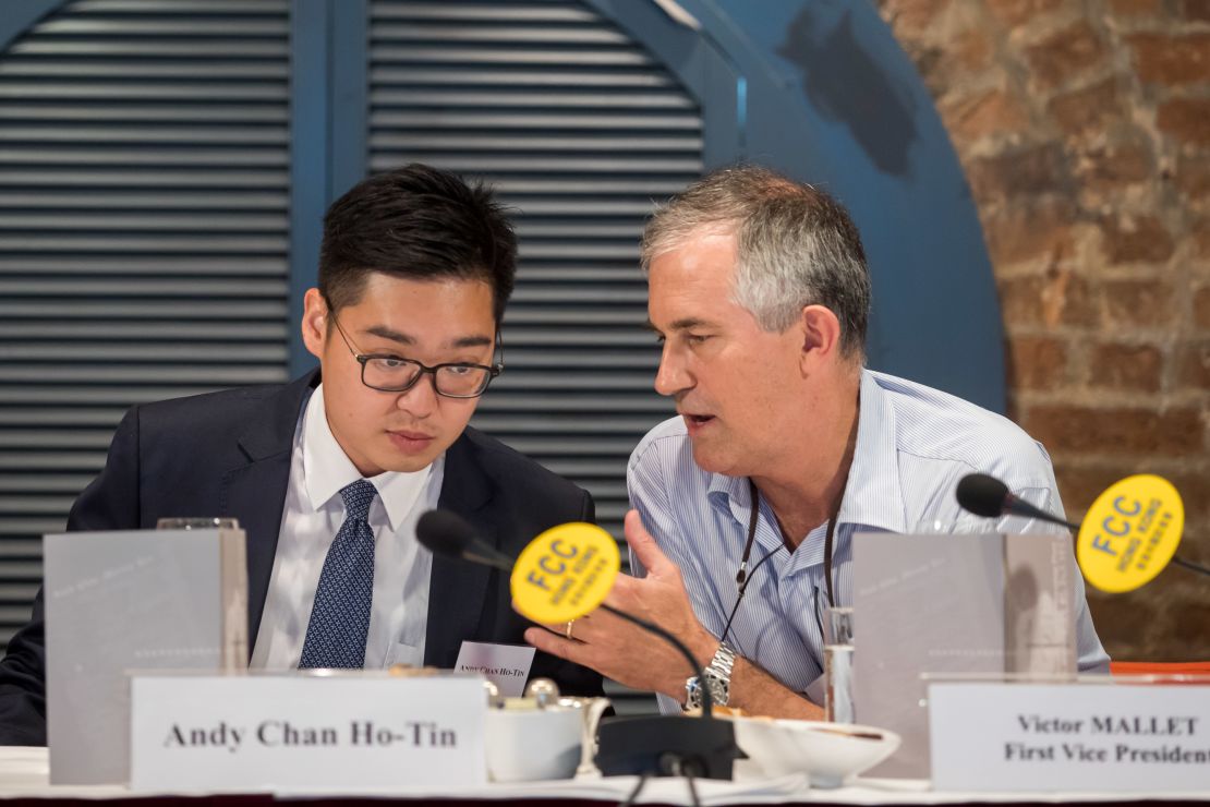 Victor Mallet, a Financial Times journalist and vice president of the Foreign Correspondents' Club (FCC) (right) speaks with Andy Chan, founder of the Hong Kong National Party, during a luncheon at the FCC in Hong Kong.