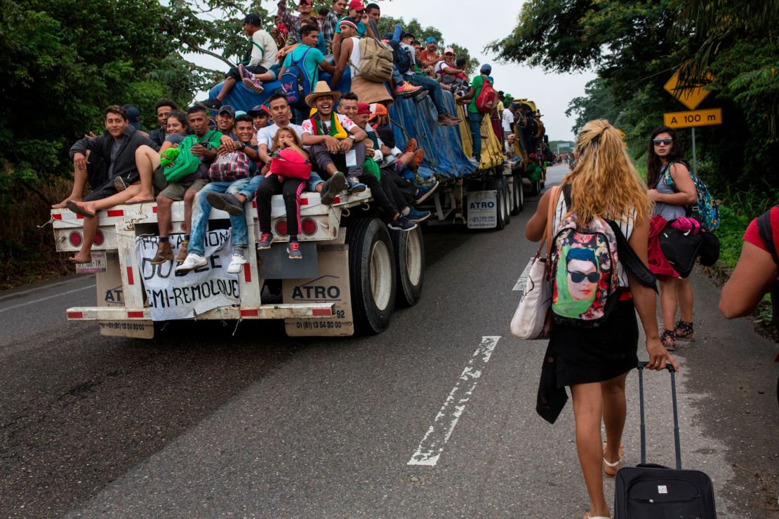 In this November 2, 2018 photo, Central American migrants who hitched a ride on a flatbed truck jeer at LGBT migrants on the road to Donaji, Mexico. For the dozens of transgender women and gay men, the journey has meant putting up with insulting catcalls and even some physical abuse. 