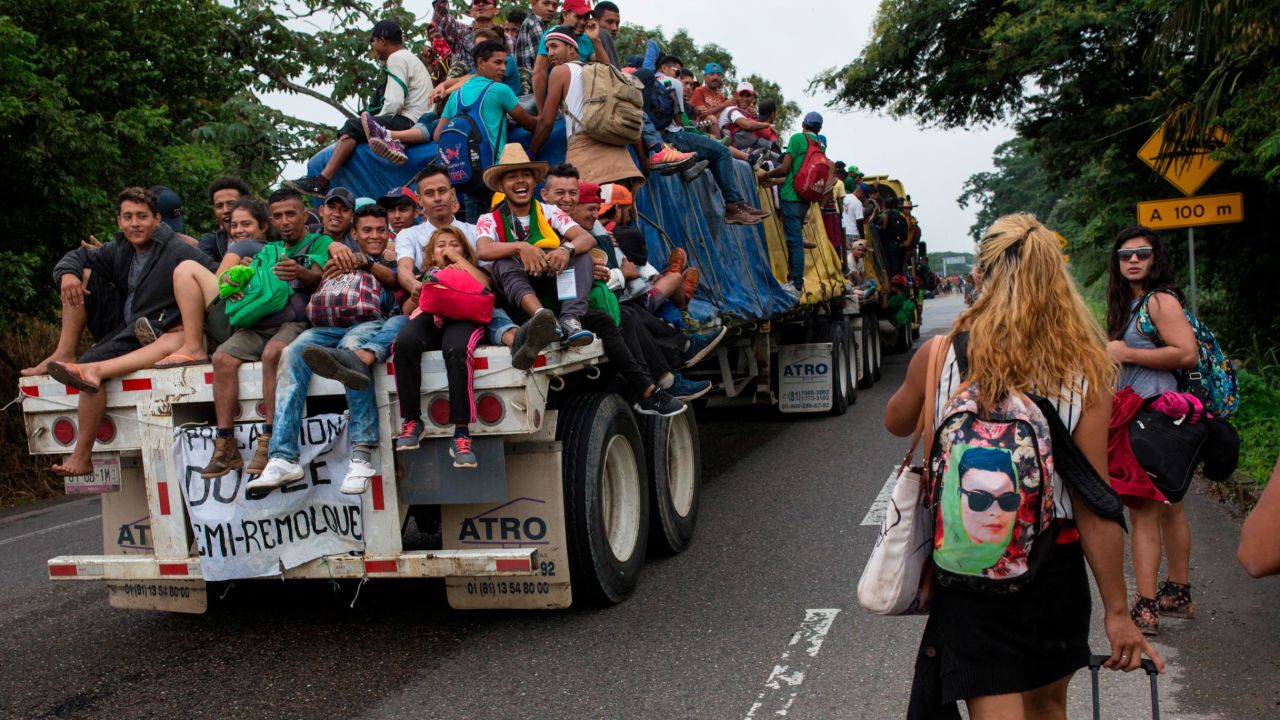 In this November 2, 2018 photo, Central American migrants who hitched a ride on a flatbed truck jeer at LGBT migrants on the road to Donaji, Mexico. For the dozens of transgender women and gay men, the journey has meant putting up with insulting catcalls and even some physical abuse. 