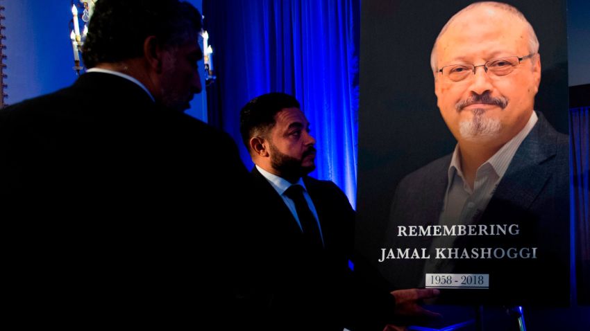 "Justice For Jamal" Campaign leader Ahmed Bedier (C) adjust the portrait of late Washington Post journalist Jamal Khashoggi during a remembrance ceremony for him in Washington, DC, on November 2, 2018.