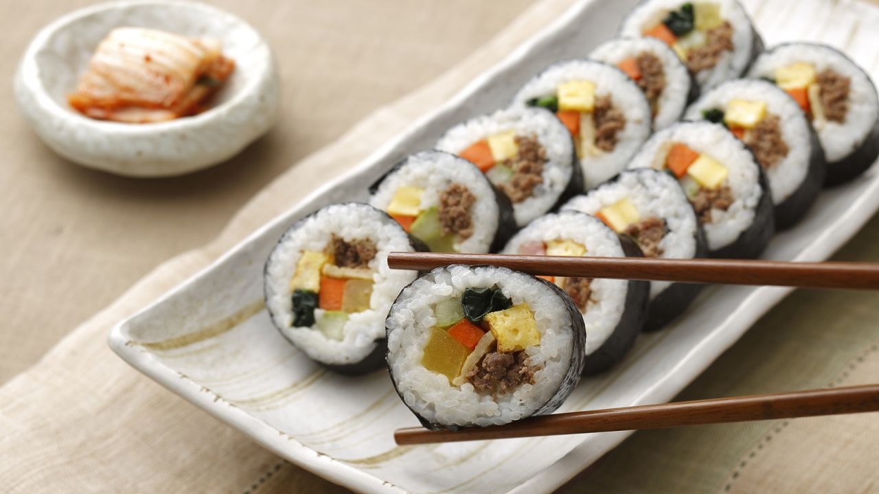 <strong>Gimbap: </strong>For this<strong> </strong>one, sauteed vegetables, ground beef, sweet pickled radish and rice are rolled and tightly wrapped in a sheet of laver seaweed (gim), and then sliced into bite-sized circles.