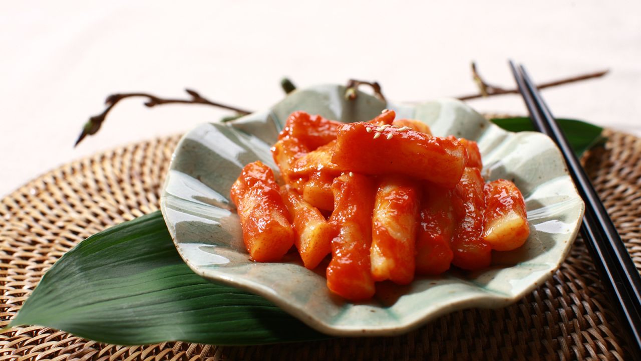 <strong>Tteokbokki: </strong>This iconic red-orange street food is so popular there's an entire town in Seoul just devoted to the steamed and sliced rice cakes (tteok), cooked with fish cakes (oden) and scallions in a sweet and spicy sauce made of chili paste.