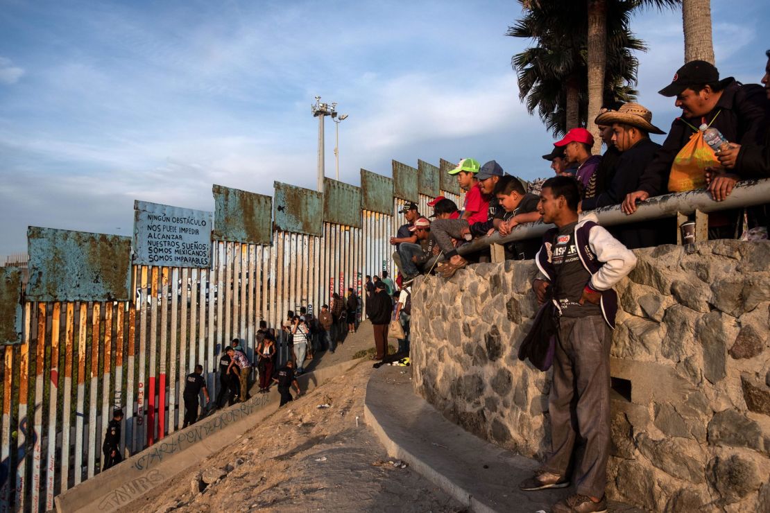 Central American migrants gathered near the US-Mexico border fence in Tijuana on Tuesday. 