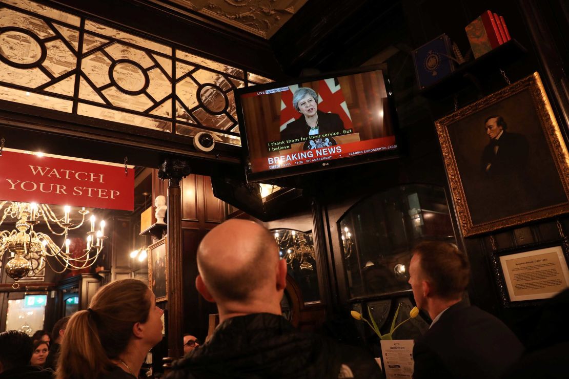 Pubgoers in London watch a broadcast of Theresa May's press conference.