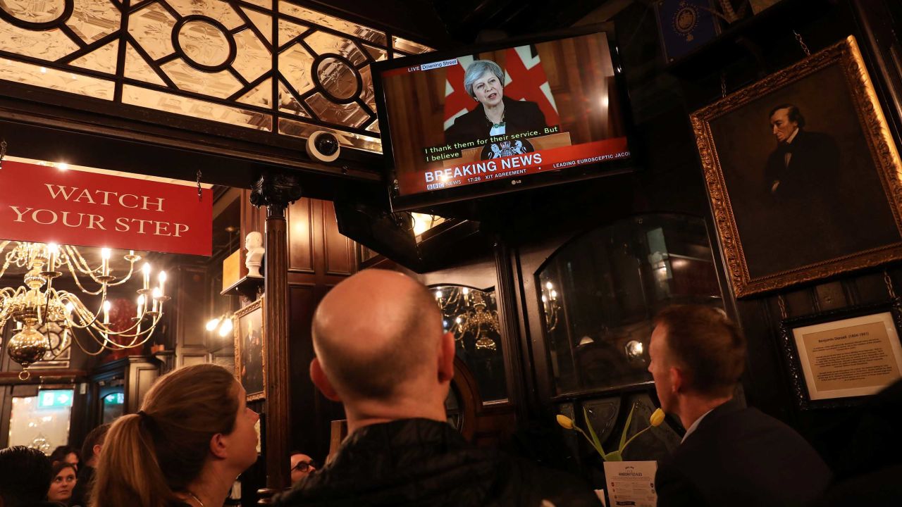 Pubgoers in London watch a broadcast of Theresa May's press conference.