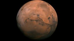 July 9, 2013Mosaic of the Valles Marineris hemisphere of Mars projected into point perspective, a view similar to that which one would see from a spacecraft. The distance is 2500 kilometers from the surface of the planet, with the scale being .6km/pixel. The mosaic is composed of 102 Viking Orbiter images of Mars. The center of the scene (lat -8, long 78) shows the entire Valles Marineris canyon system, over 2000 kilometers long and up to 8 kilometers deep, extending form Noctis Labyrinthus, the arcuate system of graben to the west, to the chaotic terrain to the east. Many huge ancient river channels begin from the chaotic terrain from north-central canyons and run north. The three Tharsis volcanoes (dark red spots), each about 25 kilometers high, are visible to the west. South of Valles Marineris is very ancient terrain covered by many impact craters.CreditNASA/JPL-Caltech