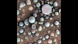 The small spherules on the Martian surface in this close-up image are near Fram Crater, visited by NASA's Mars Exploration Rover Opportunity during April 2004. The area shown is 1.2 inches (3 centimeters) across. The view comes from the microscopic imager on Opportunity's robotic arm, with color information added from the rover's panoramic camera.These are examples of the mineral concretions nicknamed "blueberries." Opportunity's investigation of the hematite-rich concretions during the rover's three-month prime mission in early 2004 provided evidence of a watery ancient environment.This image was taken during the 84th Martian day, or sol, of the rover's work on Mars (April 19, 2004). The location is beside Fram Crater, which Opportunity passed on its way from Eagle Crater, where it landed, toward Endurance Crater, where it spent most of the rest of 2004. A context image is online at http://photojournal.jpl.nasa.gov/catalog/PIA05822 .CreditNASA/JPL-Caltech/Cornell/USGS