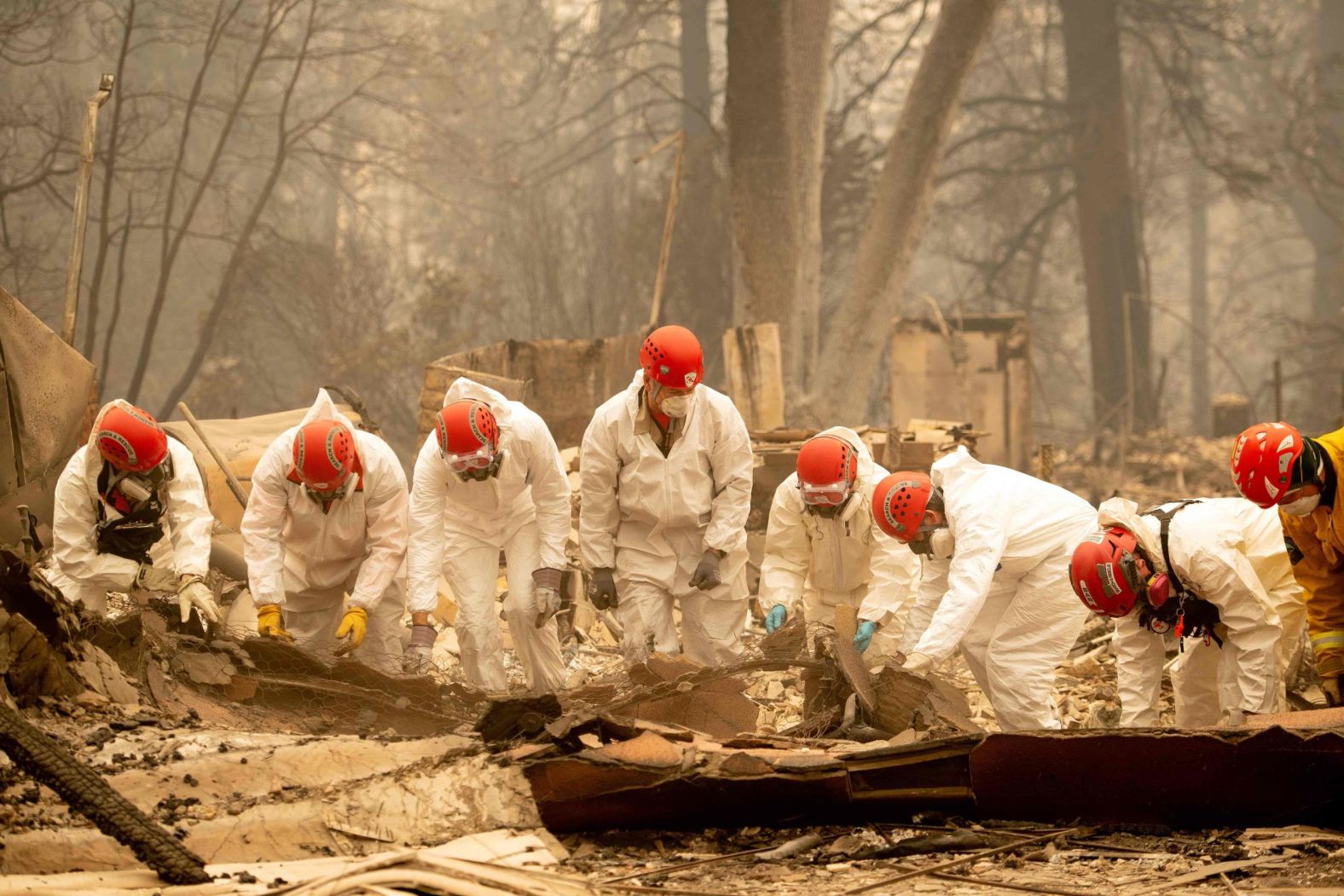 Rescue workers sift through rubble in search of human remains on Wednesday, November 14, at a burned property in Paradise.