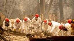 TOPSHOT - Rescue workers sift through rubble in search of human remains at a burned property in Paradise, California on November 14, 2018. - Firefighters backed by air tankers and helicopters battled California's raging wildfires for a seventh day on Wednesday as the authorities in the worst-hit county released a list of over 100 missing people. At least 51 deaths have been reported so far from the deadliest wildfires in California's recent history and body recovery teams were going house-to-house with cadaver dogs in Paradise. (Photo by Josh Edelson / AFP)JOSH EDELSON/AFP/Getty Images