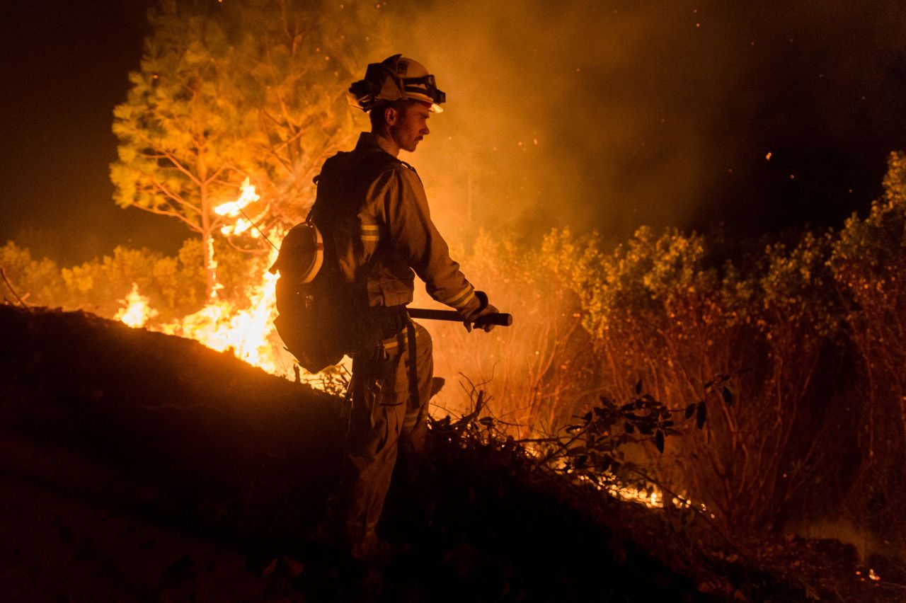 Firefighters work to control the Camp Fire on November 14 north of Oroville, California.