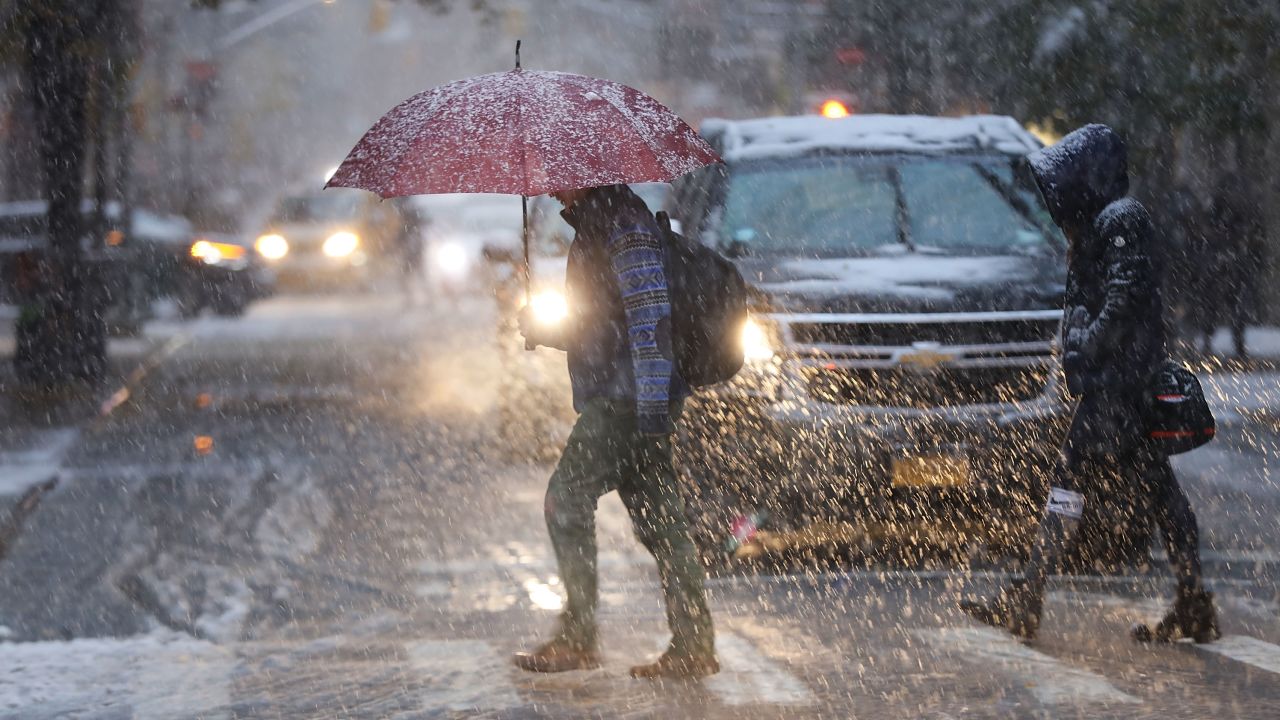 Pedestrians push through a wintry mix of snow and ice Thursday in New York.