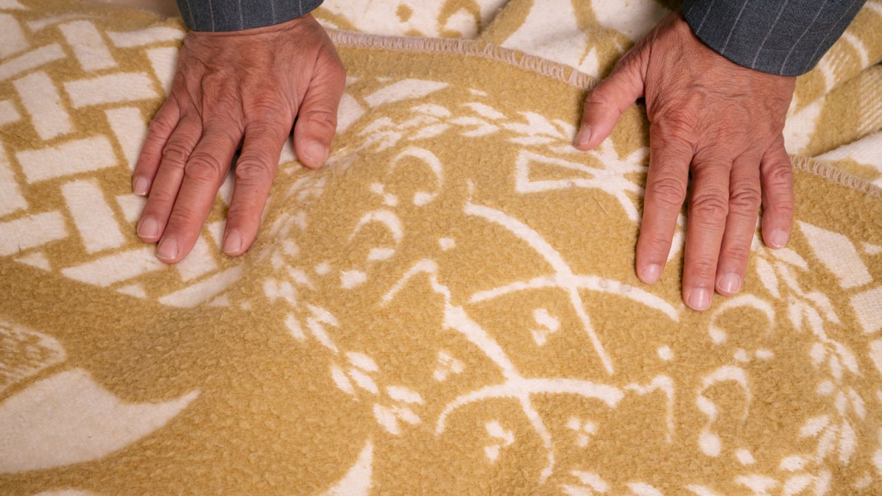 Larian still has the blanket his mother gave him when he left Iran and came to the US.