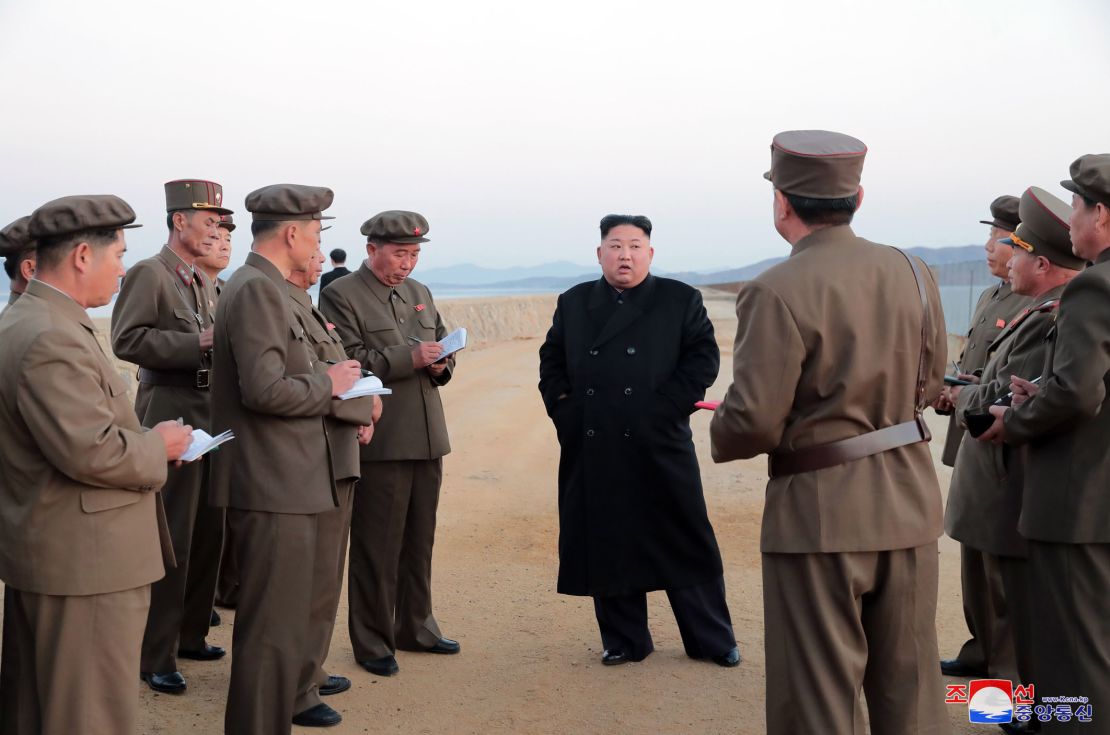 In this undated photo released on Friday by the North Korean government, Kim Jong Un, listens to a military official as he inspects a weapon testing.