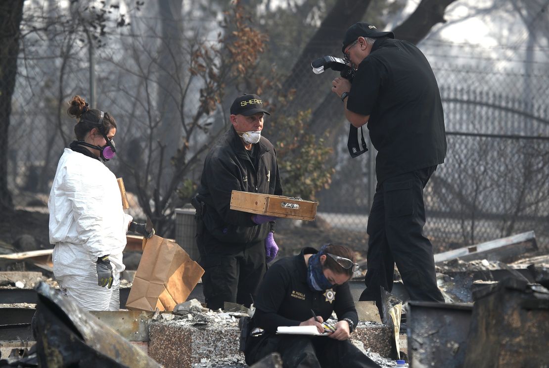 Searchers work at a property in Paradise, Calfiornia, where human remains were found Friday.