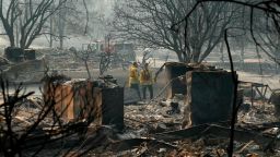 Firefighters search for human remains in a trailer park destroyed in the Camp Fire, Friday, Nov. 16, 2018, in Paradise, Calif. (AP Photo/John Locher)