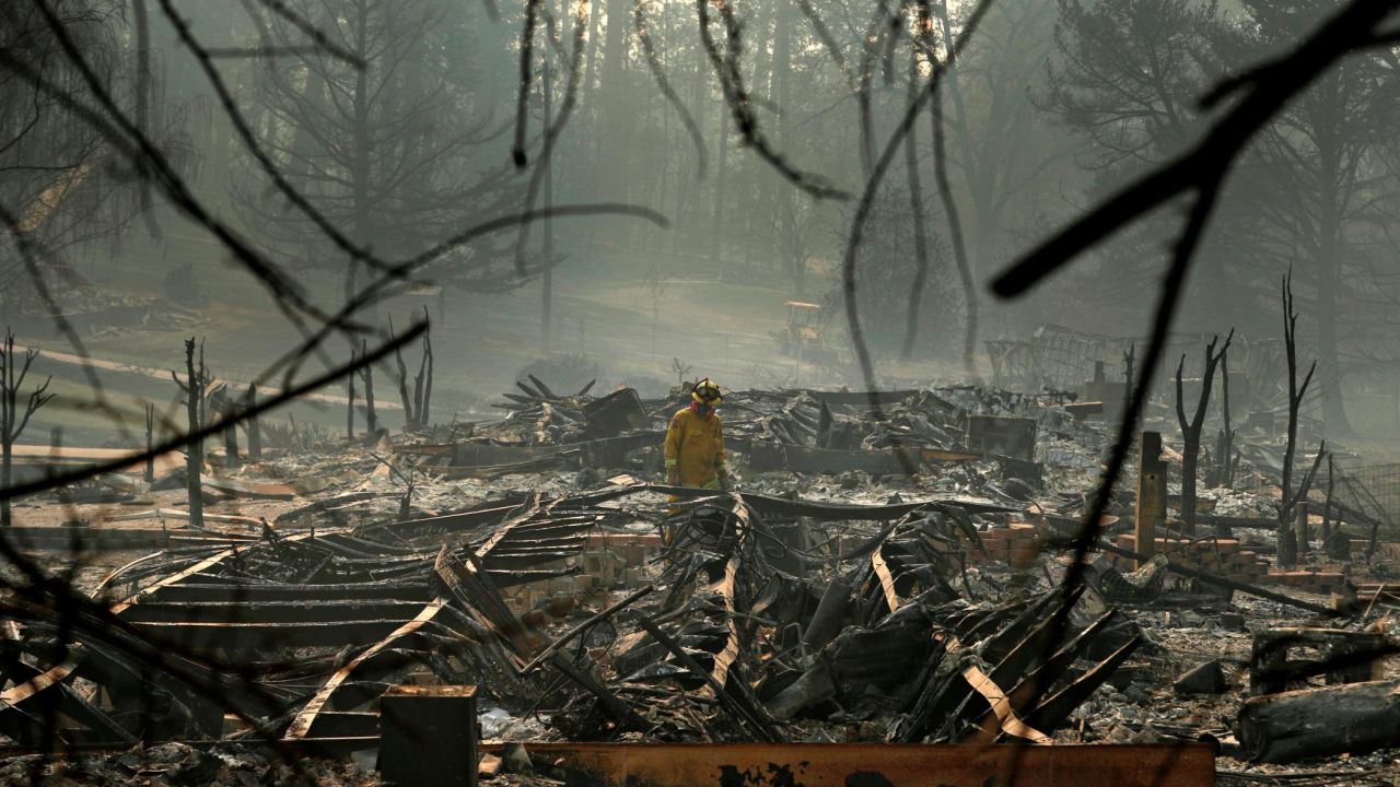 A firefighter searches for human remains November 16 in a trailer park destroyed in the Camp Fire.