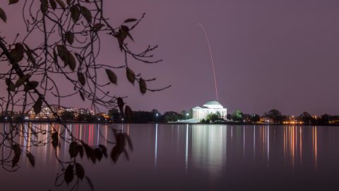 The Northrop Grumman Antares rocket is seen on November 17 above the Thomas Jefferson Memorial as it launches, this long-exposure photo released by NASA shows.