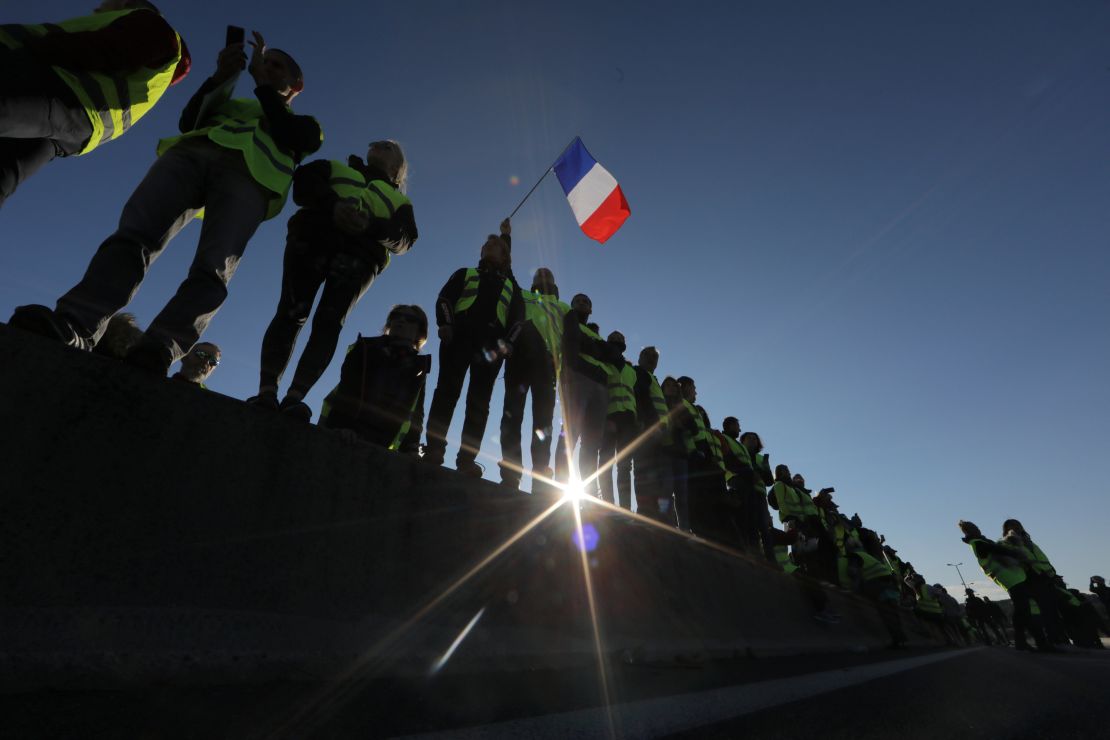 People wearing yellow vests block the motorway in Antibes, southeastern France, on Saturday.