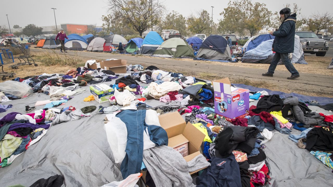 A Camp Fire evacuee walks through the makeshift tent city in Chico.