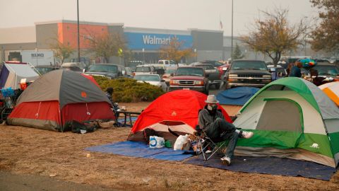People displaced by the Camp Fire have set up tents outside a Walmart store.