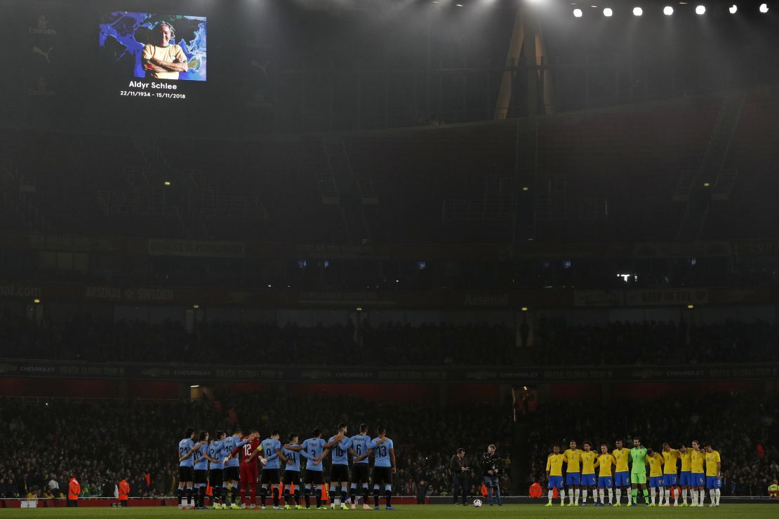 Uruguay and Brazil players honor Schlee with a minute's silence ahead of an international friendly in London on Friday.
